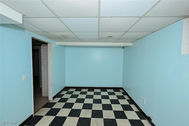 basement with a paneled ceiling