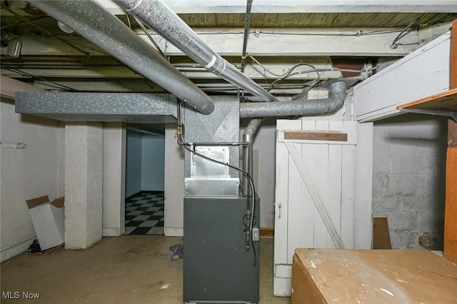 utility room featuring heating unit