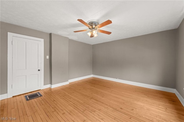 unfurnished room featuring hardwood / wood-style floors, a textured ceiling, and ceiling fan