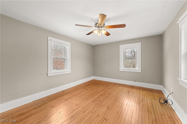 spare room featuring light hardwood / wood-style flooring and ceiling fan