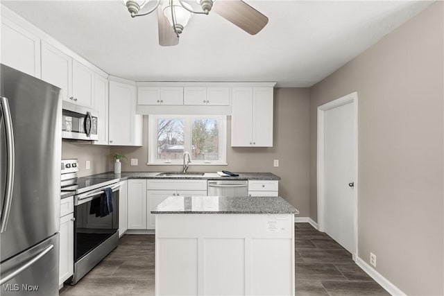 kitchen featuring white cabinetry, sink, a center island, and stainless steel appliances