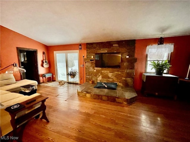 living room featuring hardwood / wood-style flooring and vaulted ceiling