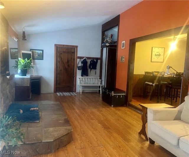 interior space with hardwood / wood-style floors and lofted ceiling