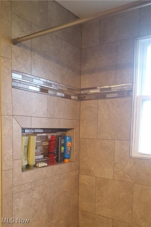 bathroom with a tile shower