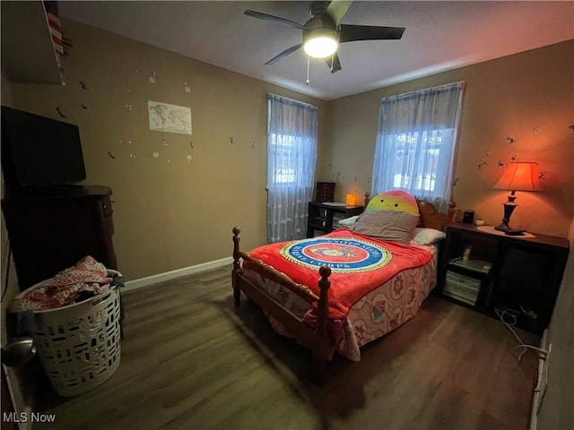 bedroom with ceiling fan and dark wood-type flooring