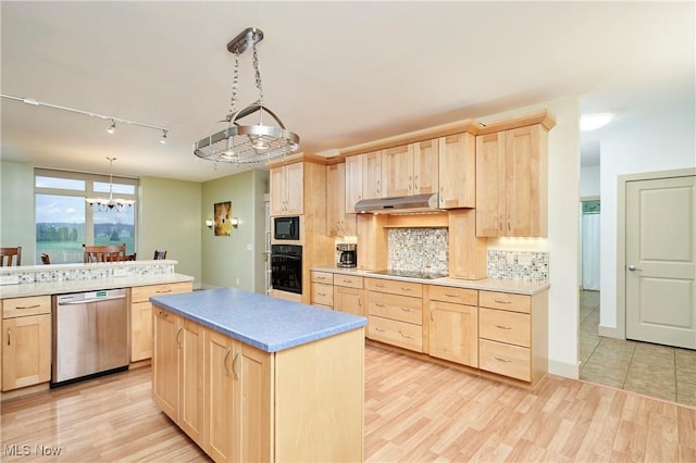 kitchen with light brown cabinetry, black appliances, pendant lighting, light hardwood / wood-style flooring, and a chandelier