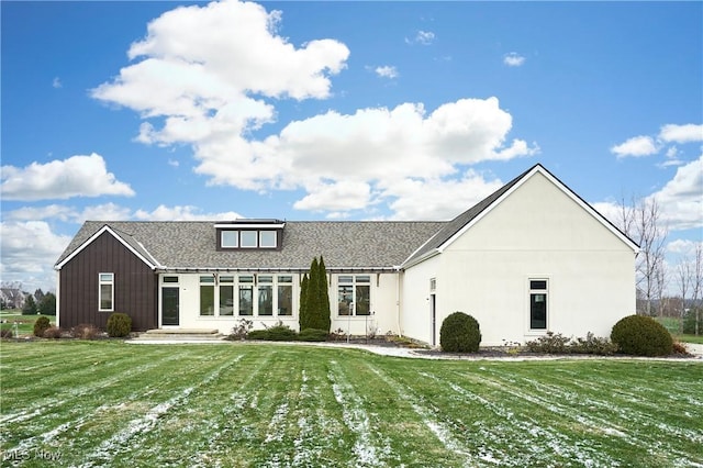 rear view of property with a yard