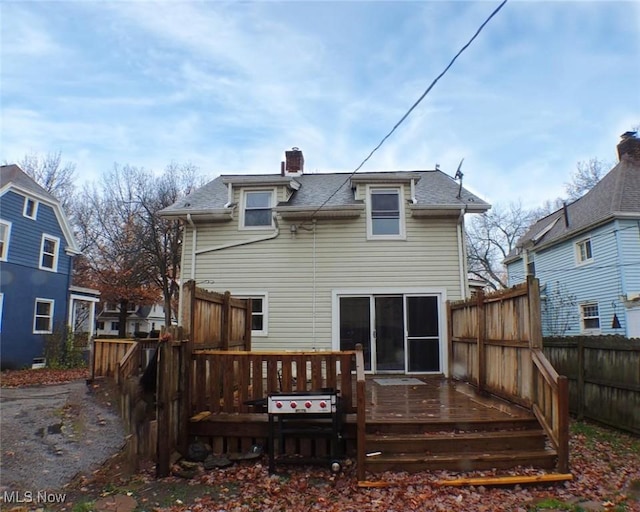 back of house featuring a wooden deck