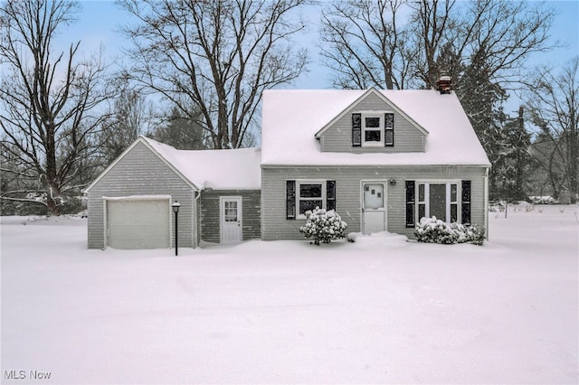 cape cod house featuring a garage