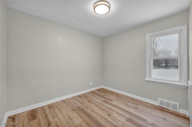 unfurnished room with light wood-type flooring