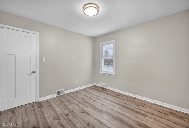 unfurnished room with light hardwood / wood-style floors