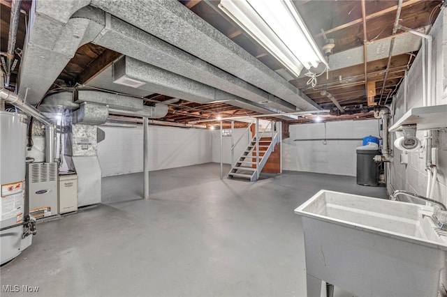 basement with gas water heater and sink