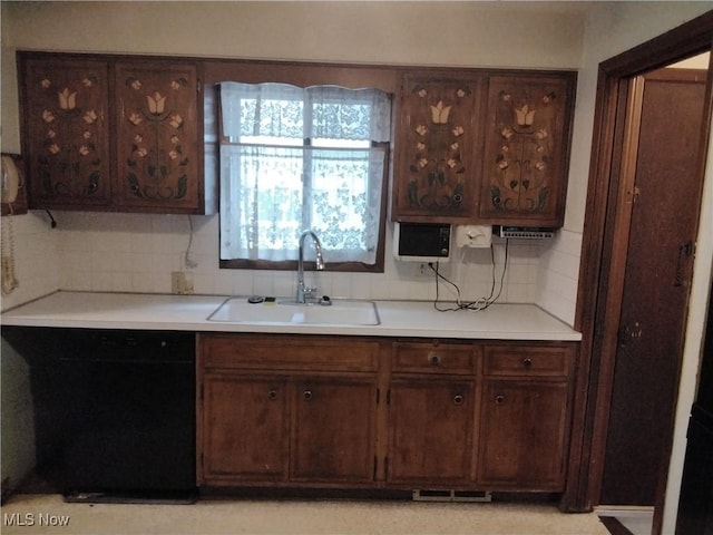 kitchen with backsplash, dark brown cabinetry, dishwasher, and sink