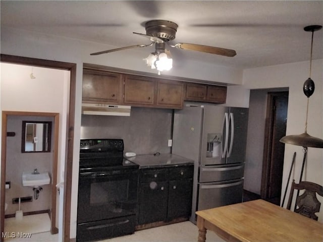 kitchen featuring stainless steel refrigerator with ice dispenser, ceiling fan, sink, black electric range, and hanging light fixtures