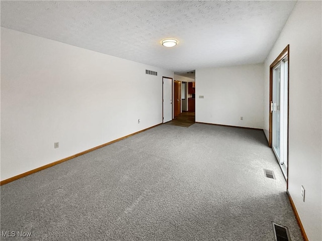 unfurnished bedroom with carpet floors and a textured ceiling