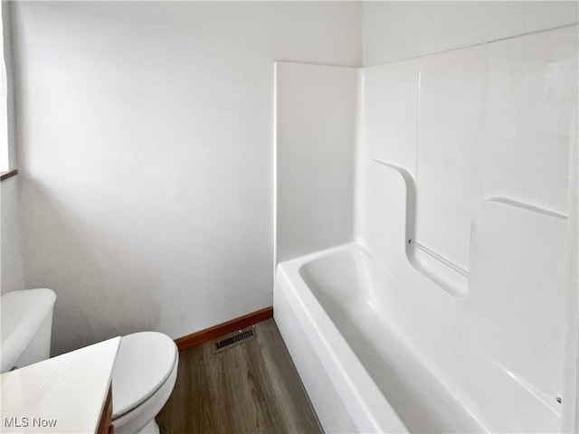 bathroom with hardwood / wood-style floors, vanity, and toilet