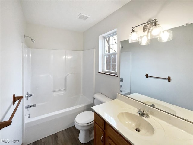 full bathroom featuring hardwood / wood-style flooring, vanity, toilet, and shower / bath combination