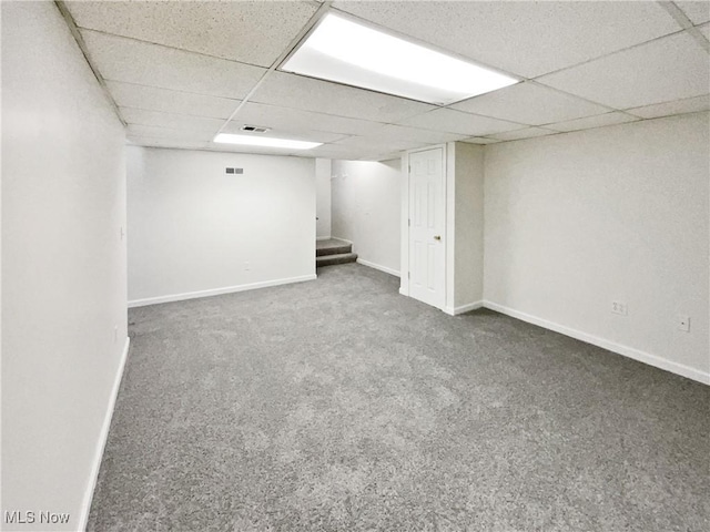 basement featuring carpet floors and a drop ceiling