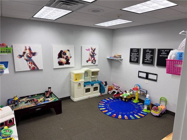 recreation room featuring a drop ceiling