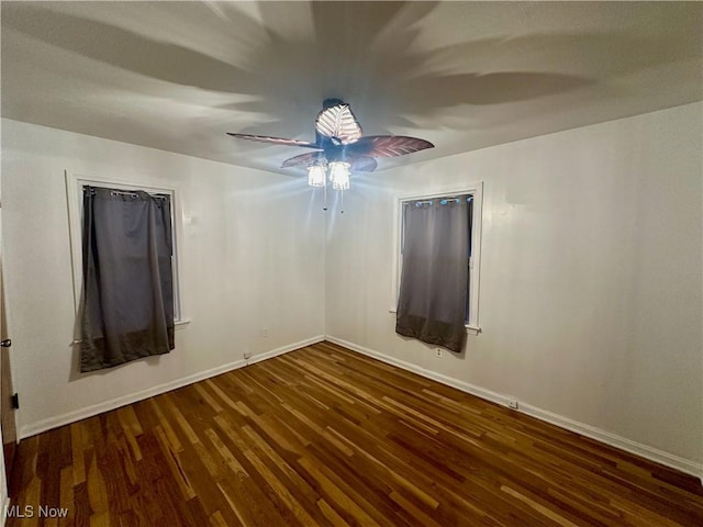 empty room with dark hardwood / wood-style flooring