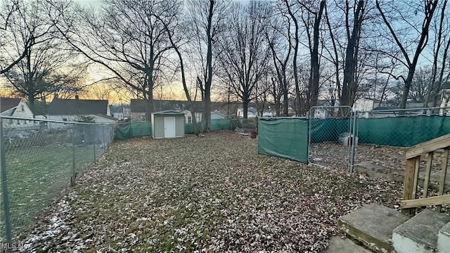 yard at dusk with a storage unit