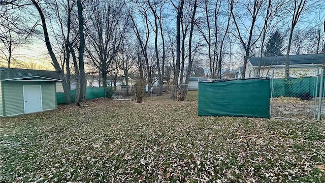 yard at dusk with a storage unit