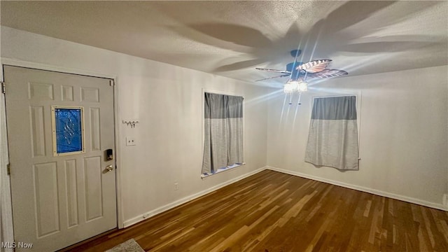 entrance foyer featuring dark hardwood / wood-style floors and a textured ceiling