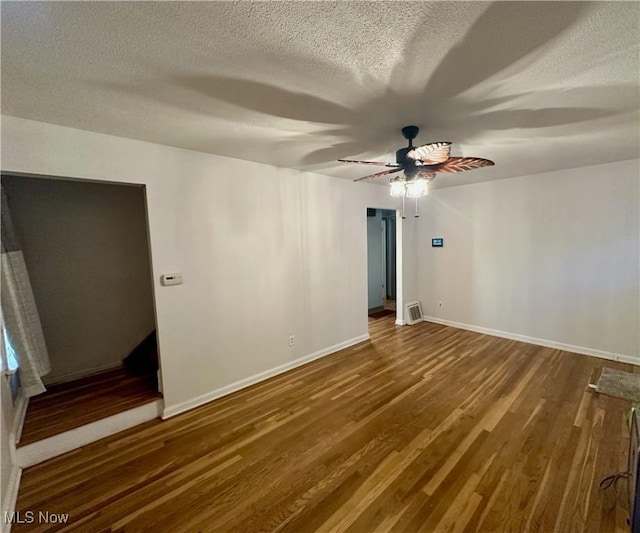 unfurnished bedroom featuring ceiling fan, a textured ceiling, and hardwood / wood-style flooring