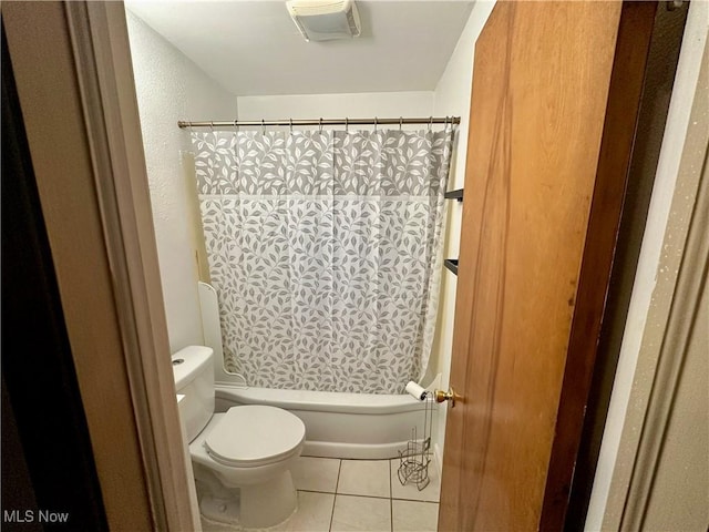 bathroom with tile patterned flooring, shower / bathtub combination with curtain, and toilet