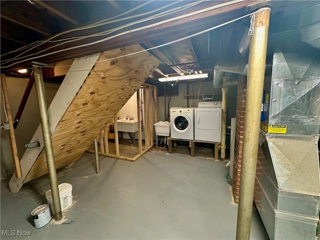 basement with washer and clothes dryer and sink