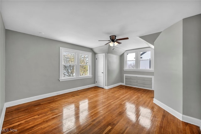 bonus room featuring vaulted ceiling, light hardwood / wood-style flooring, a wealth of natural light, and ceiling fan