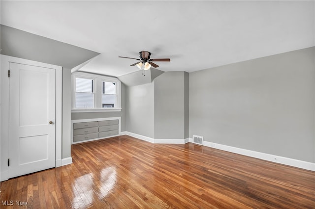 additional living space featuring ceiling fan, lofted ceiling, and light hardwood / wood-style flooring