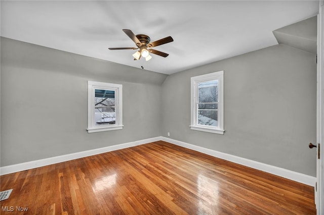 additional living space with hardwood / wood-style flooring, plenty of natural light, ceiling fan, and lofted ceiling