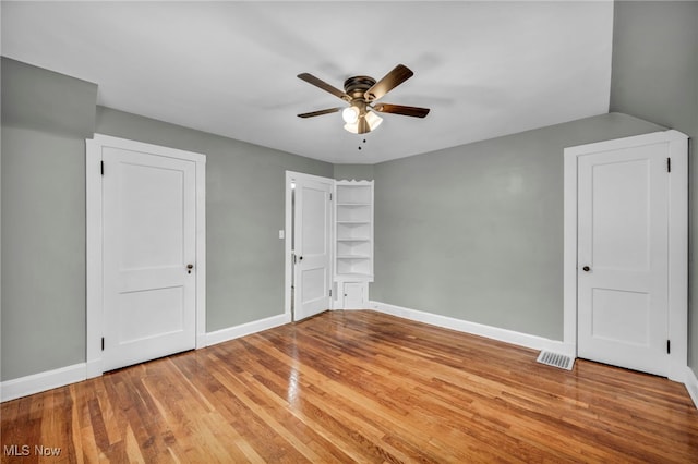 unfurnished bedroom with ceiling fan and light hardwood / wood-style flooring