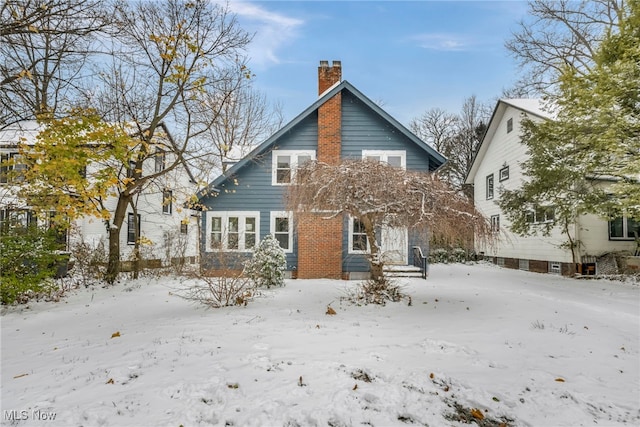 view of snow covered rear of property