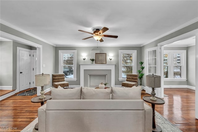 living room with plenty of natural light, ornamental molding, and hardwood / wood-style flooring