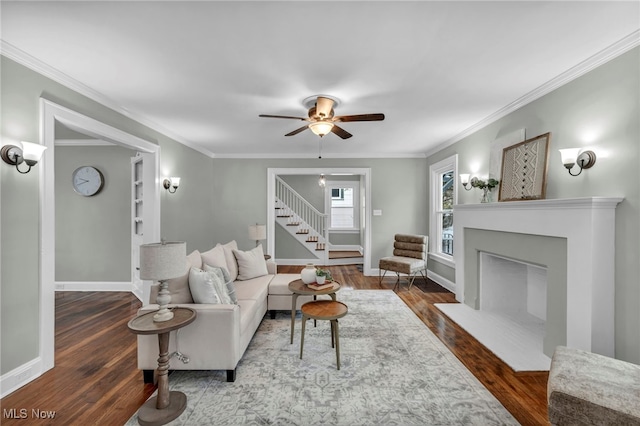 living room featuring ceiling fan, dark hardwood / wood-style flooring, and ornamental molding