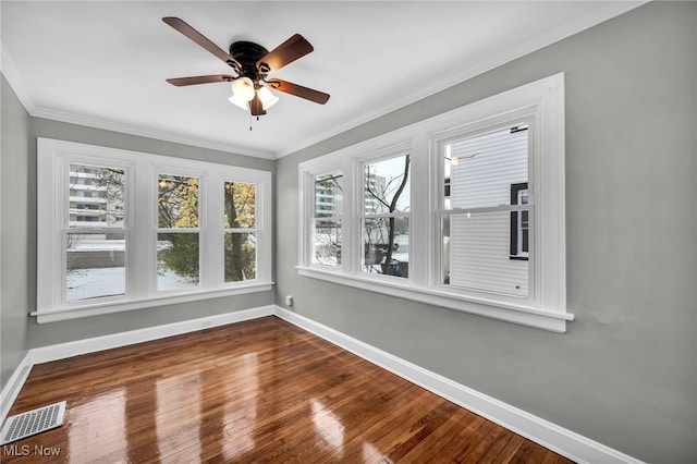 unfurnished sunroom featuring ceiling fan