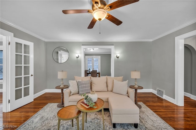 living room featuring french doors, crown molding, ceiling fan, and dark wood-type flooring