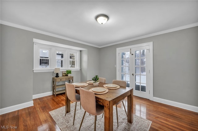 dining room featuring ornamental molding, dark wood-type flooring, and french doors