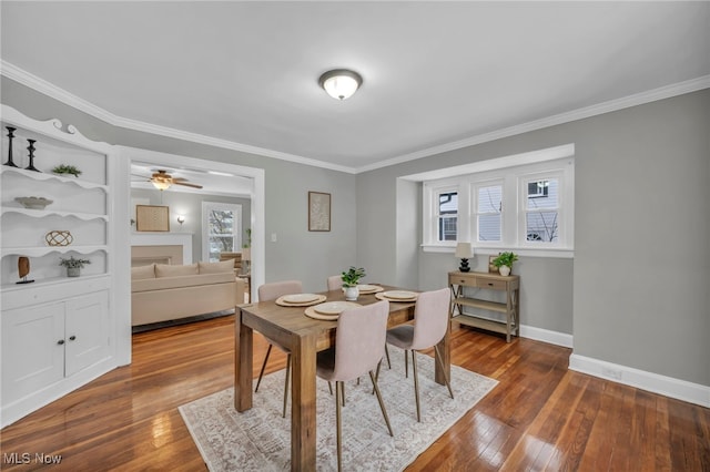 dining area featuring crown molding, hardwood / wood-style floors, and ceiling fan