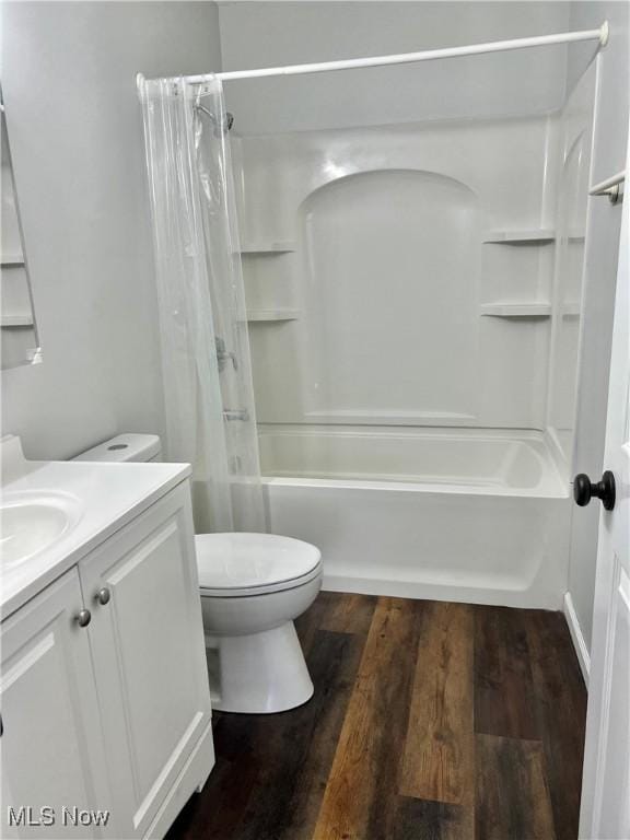 full bathroom featuring hardwood / wood-style floors, vanity, and shower / tub combo with curtain