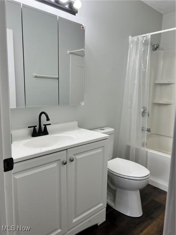 full bathroom featuring hardwood / wood-style floors, vanity, toilet, and shower / bath combo