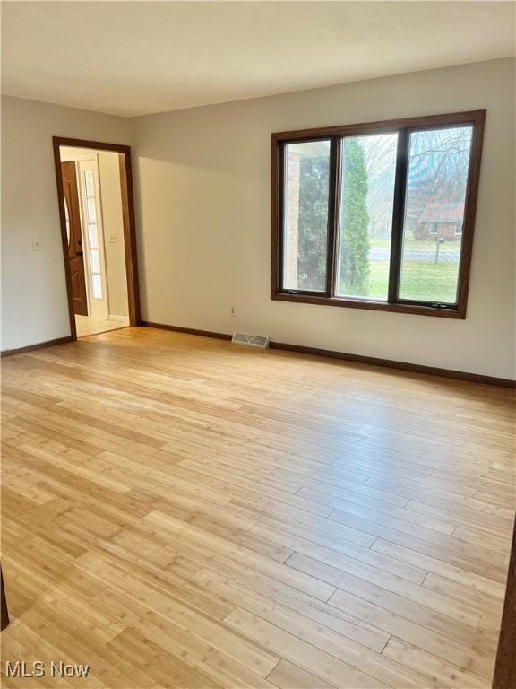 unfurnished room with light hardwood / wood-style floors