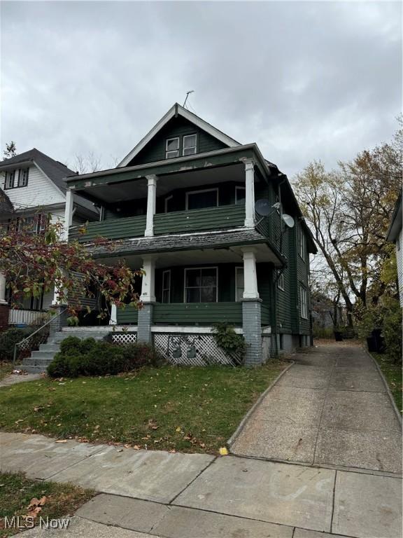 view of front of property with a porch and a front yard