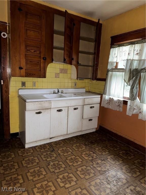 kitchen with white cabinets and decorative backsplash