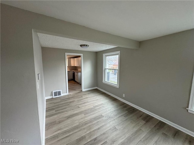 unfurnished room with light hardwood / wood-style floors