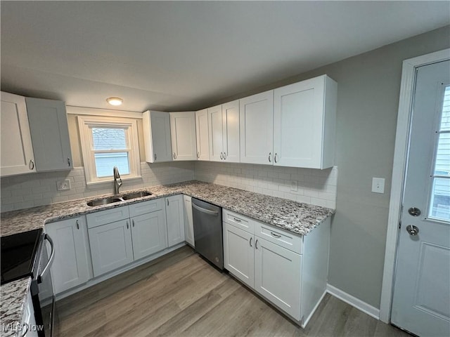 kitchen with black range, sink, stainless steel dishwasher, light hardwood / wood-style floors, and white cabinetry