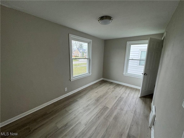 unfurnished room featuring light wood-type flooring