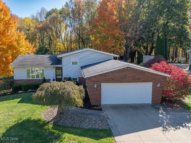 view of front of property with a front yard and a garage